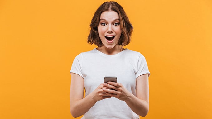 woman-mouth-open-looking-at-phone-680x382